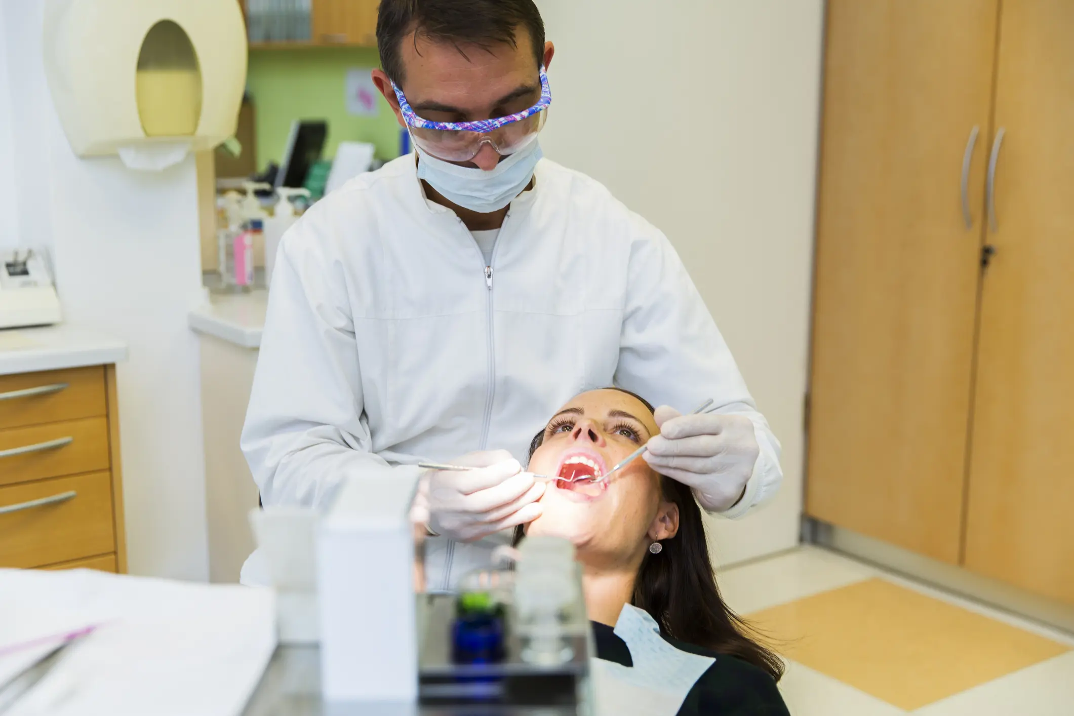 Cute young women at the dentist sitting in dentist chair....dentist working